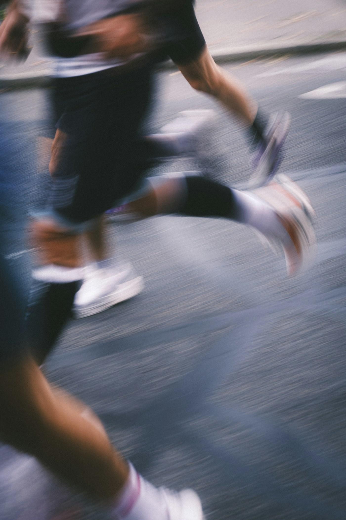 Runners passing at speed, captured with motion blur